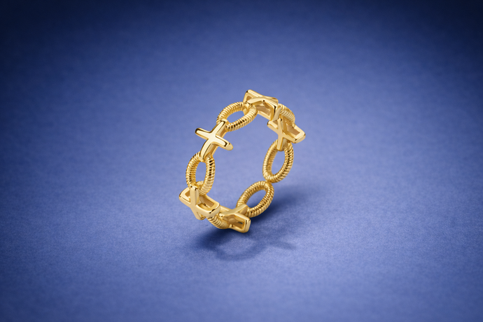 Gold ring with intricate design on a blue background