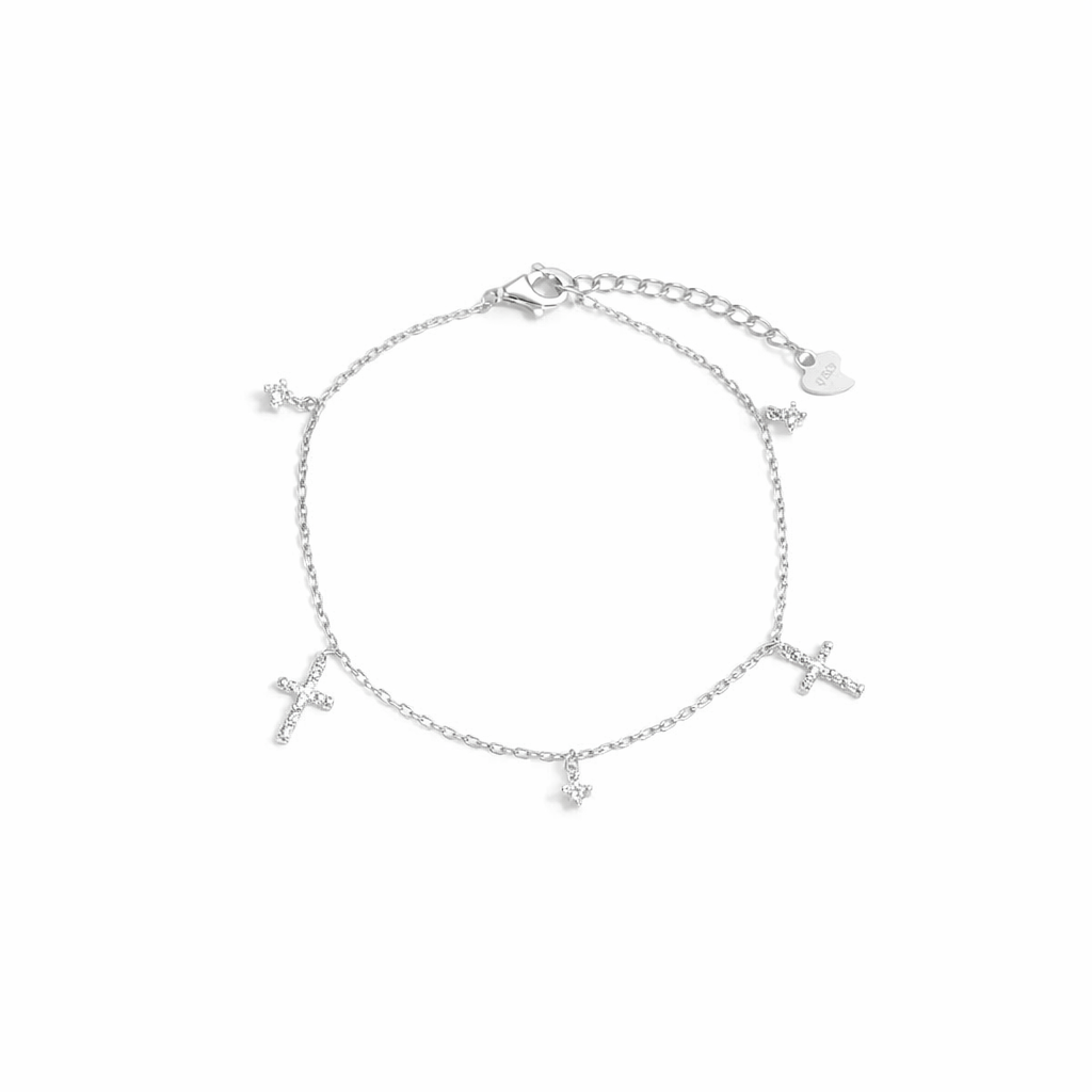 Silver bracelet with heart and cross charms on a white background