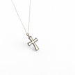 Silver cross pendant necklace on a white background