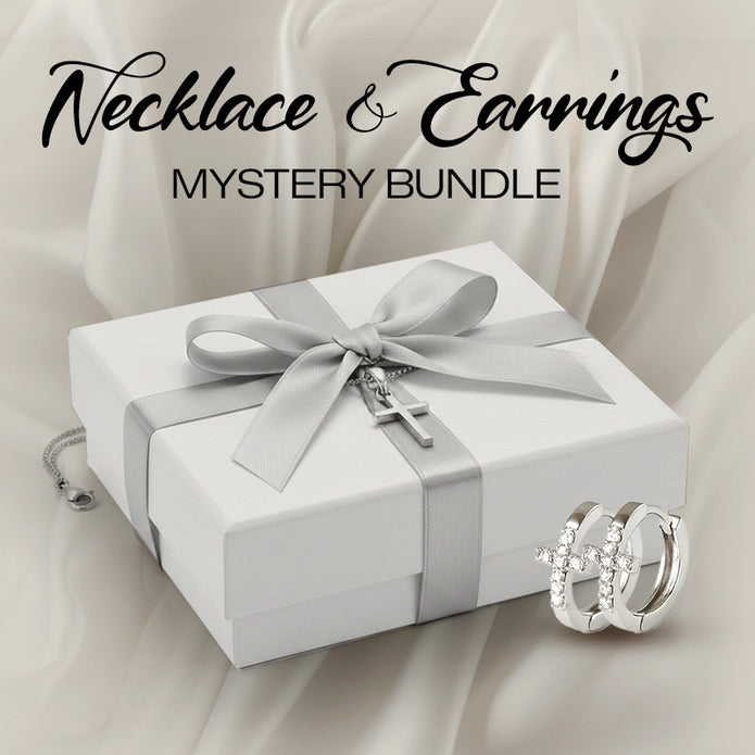 Jewelry set with necklace and earrings on a white box with silver ribbon, against a beige fabric background.