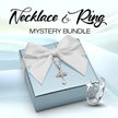 Jewelry set with necklace and ring on a box with a white bow, labeled 'Necklace & Ring Mystery Bundle'.